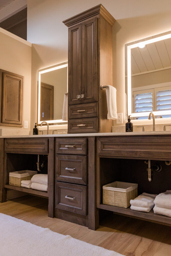 Primary bathroom, double sink vanity that is stained dark with LED mirrors